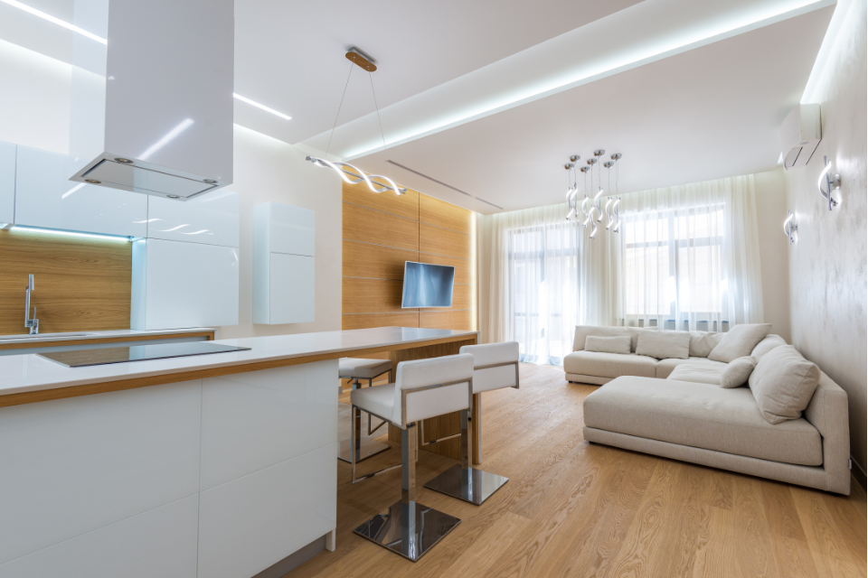 Gold Coast unit interior with bright white kitchen and wooden floors